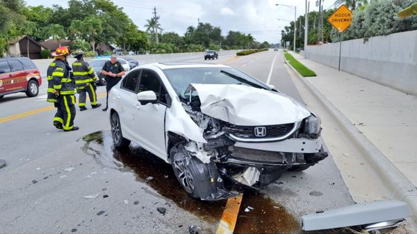 A 27-year-old Florida woman suffered only minor injuries when her car crashed into a pole Tuesday morning following a spider sighting.